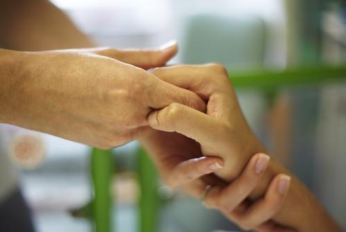A GOSH patient and Occupational Therapist's hands